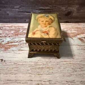 Vintage metal trinket box a Victorian boy on top inside is lined w/green velvet